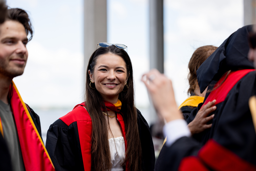 Graduates smile outside
