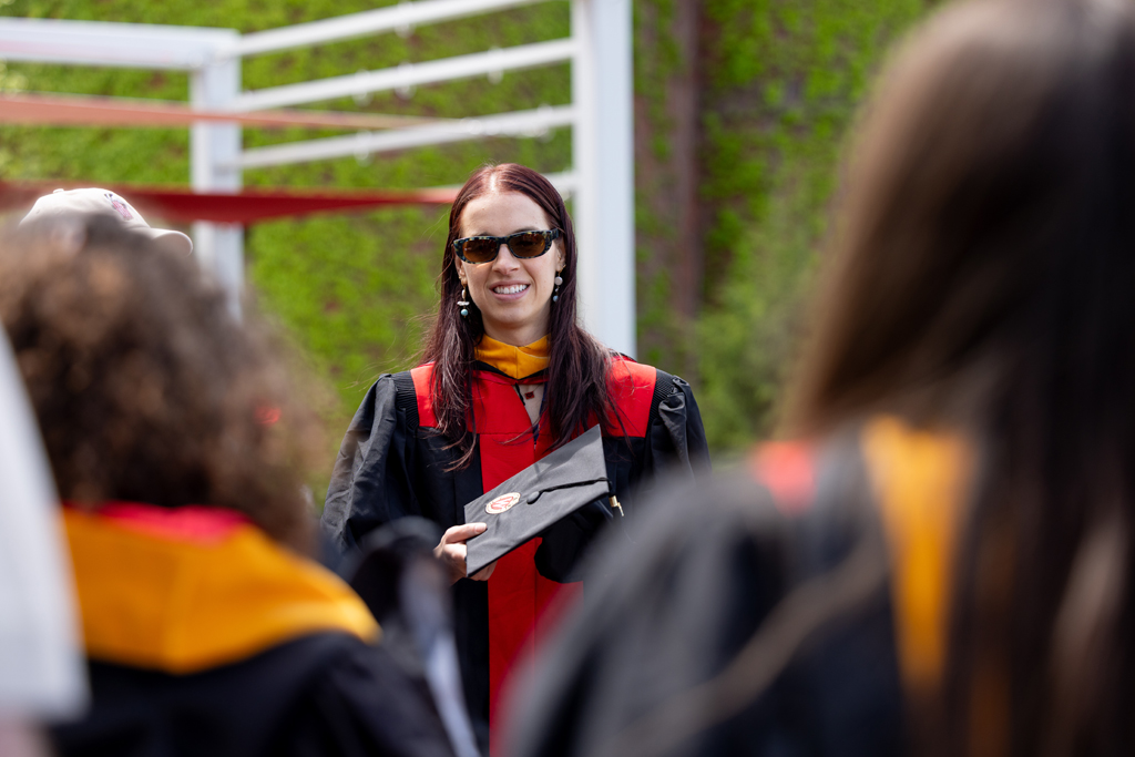 Graduates smile outside