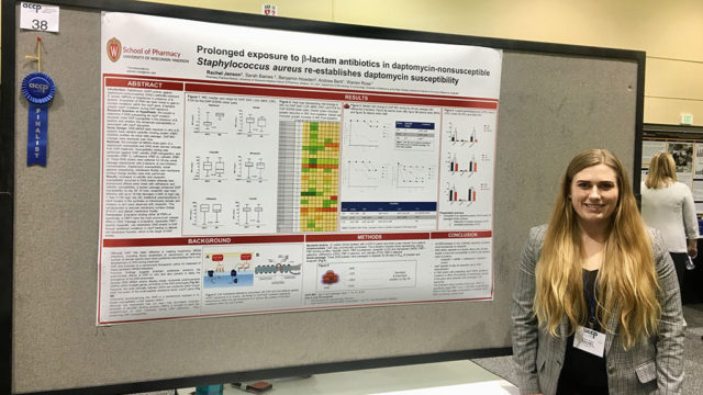 Rachel Jenson standing with her research poster
