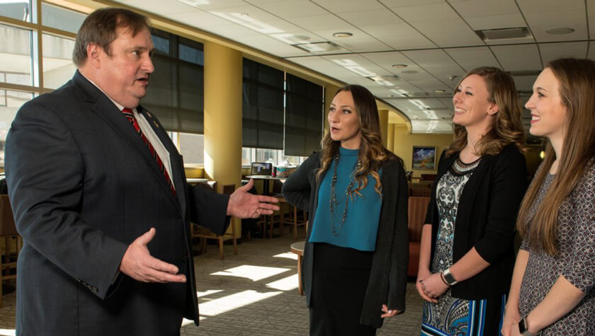 Dean Steve Swanson speaking with PharmD students before the Rho Chi induction ceremony