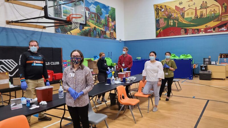 School of pharmacy students volunteering at a set-up vaccine clinic in the Boys & Girls Taft Club