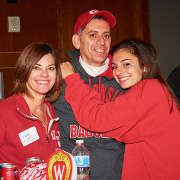 A SoP alumni family poses together at a tailgating party