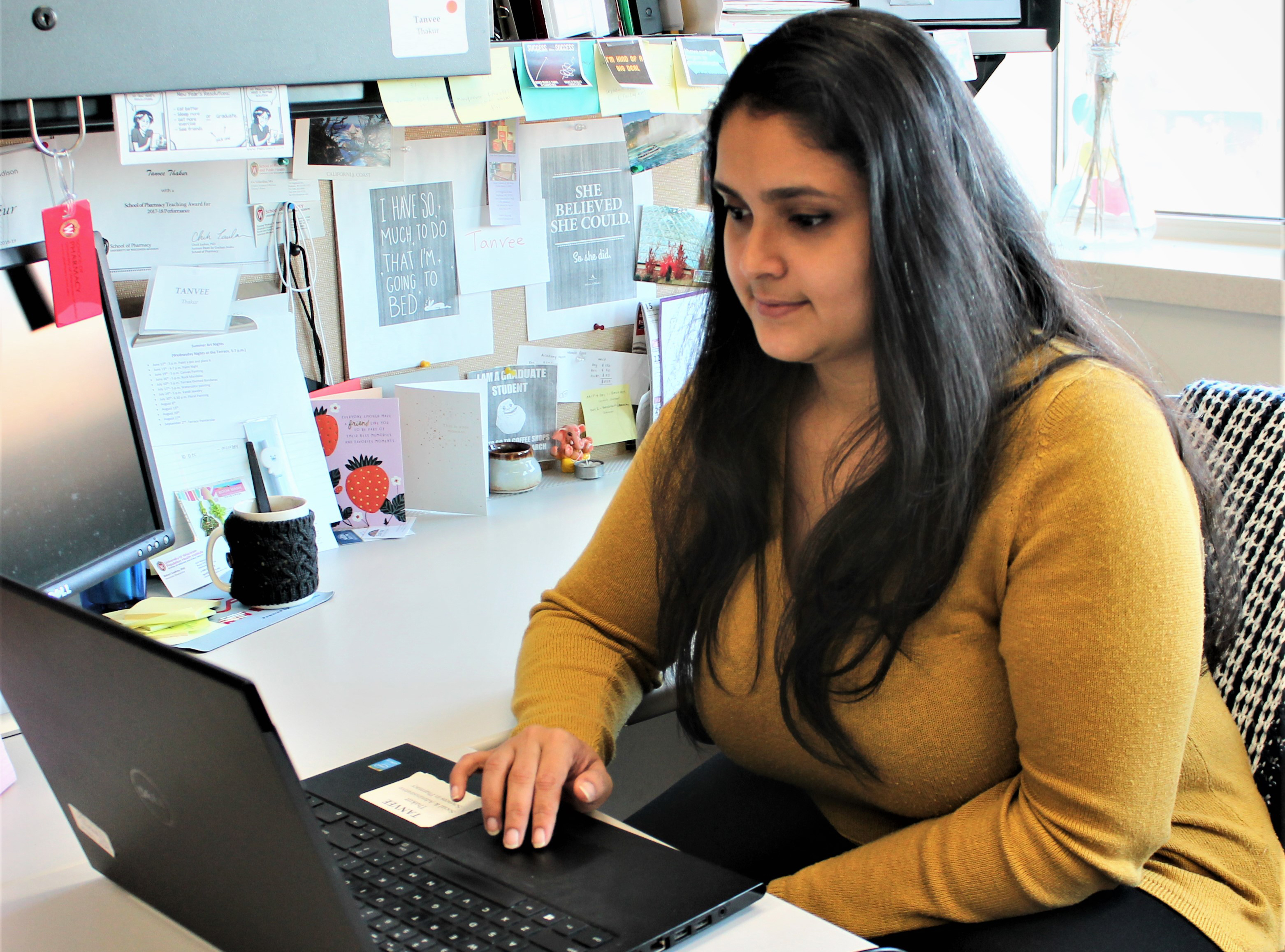 Tanvee Thakur working at her desk on laptop