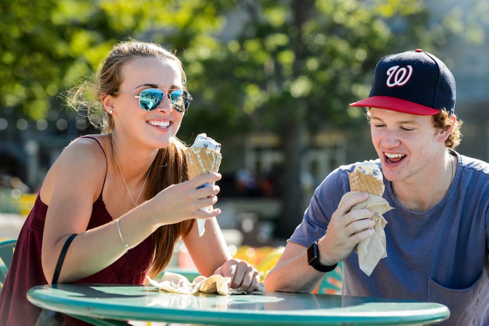 Two pharmacy students enjoy ice cream cones outdoors at the Memorial Union Terrace