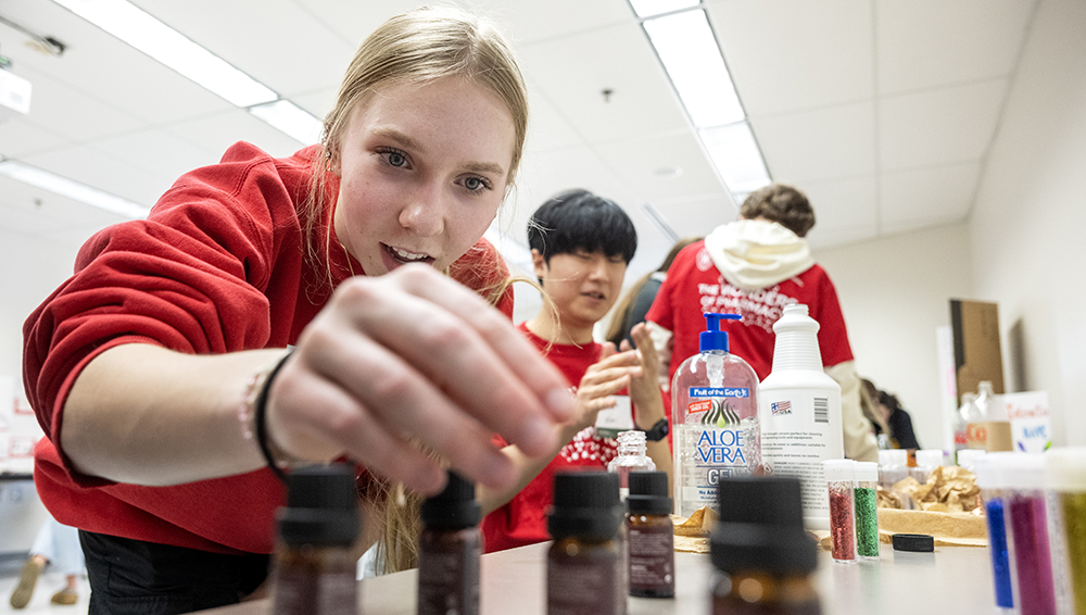 An attendee looks through vials