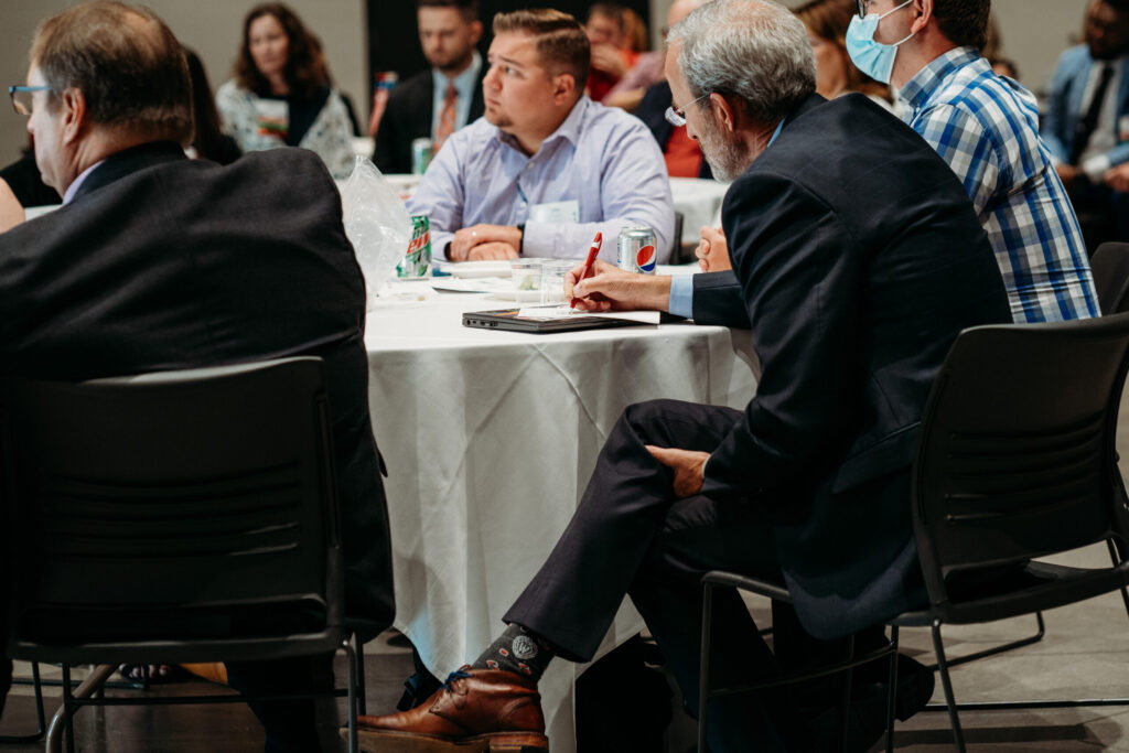 Dave Mott takes notes at a table.