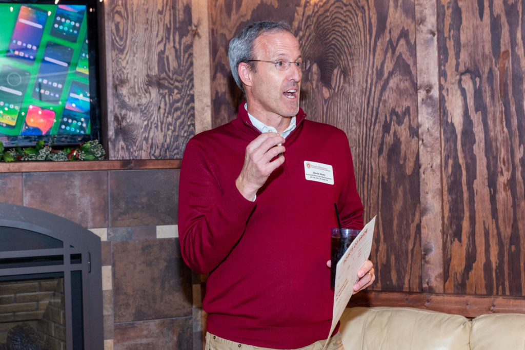 David Mott speaking for the alumni event with a paper in his hand