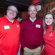 A SoP alumni family poses together at a tailgating party