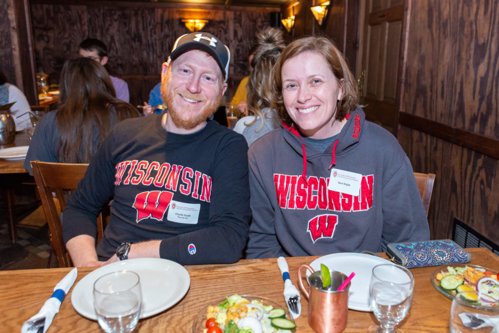 Charlie and Sara Kujak at table with plates and drinks in front of them