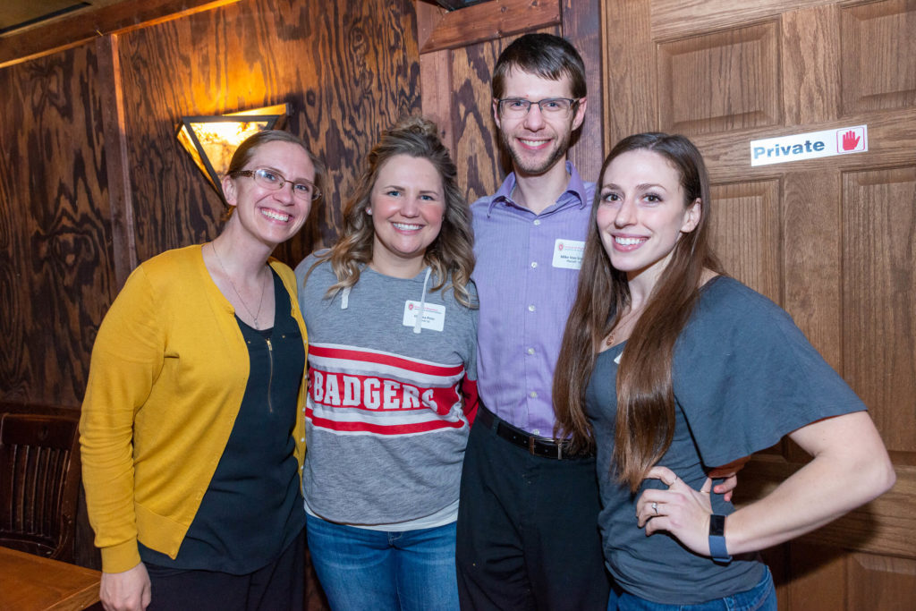 Ashley Carstens, Chelsea Pintz, Mike Van Sistine, and Katie Mechtel standing together on the wall