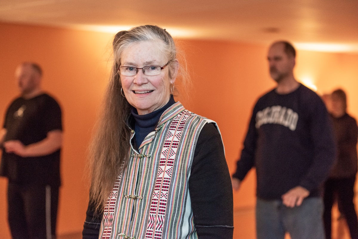 Betty Chewning with older adults spaced out behind her