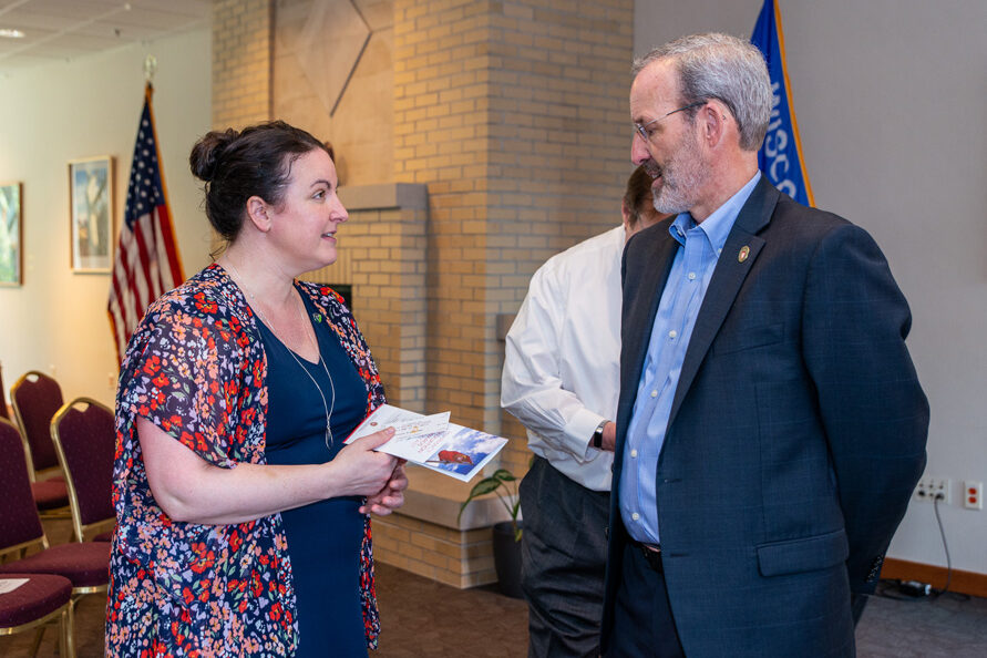 Dave Mott speaking with another faculty member