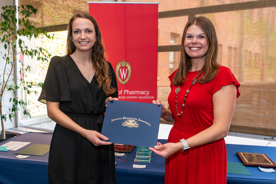 UW Pharm Award recipient holding their award