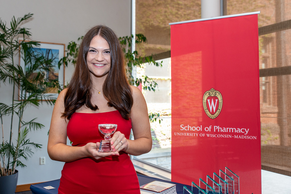 UW Pharm Award recipient holding their award