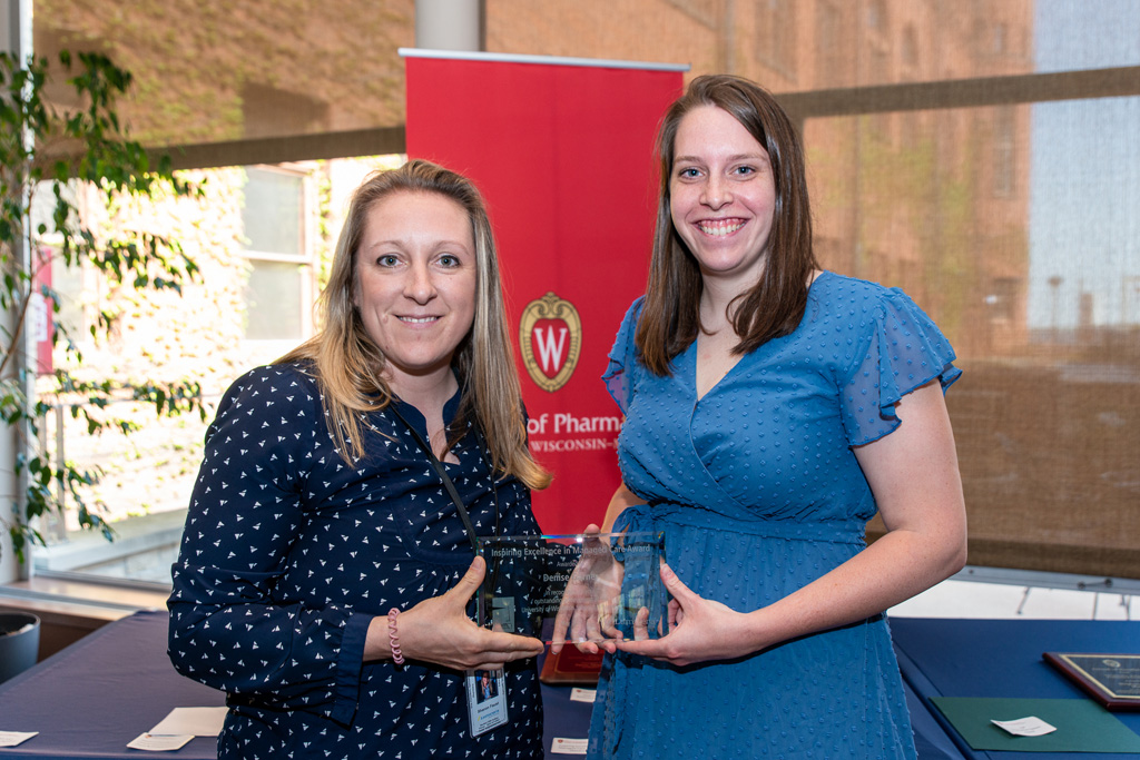 UW Pharm Award recipient holding their award