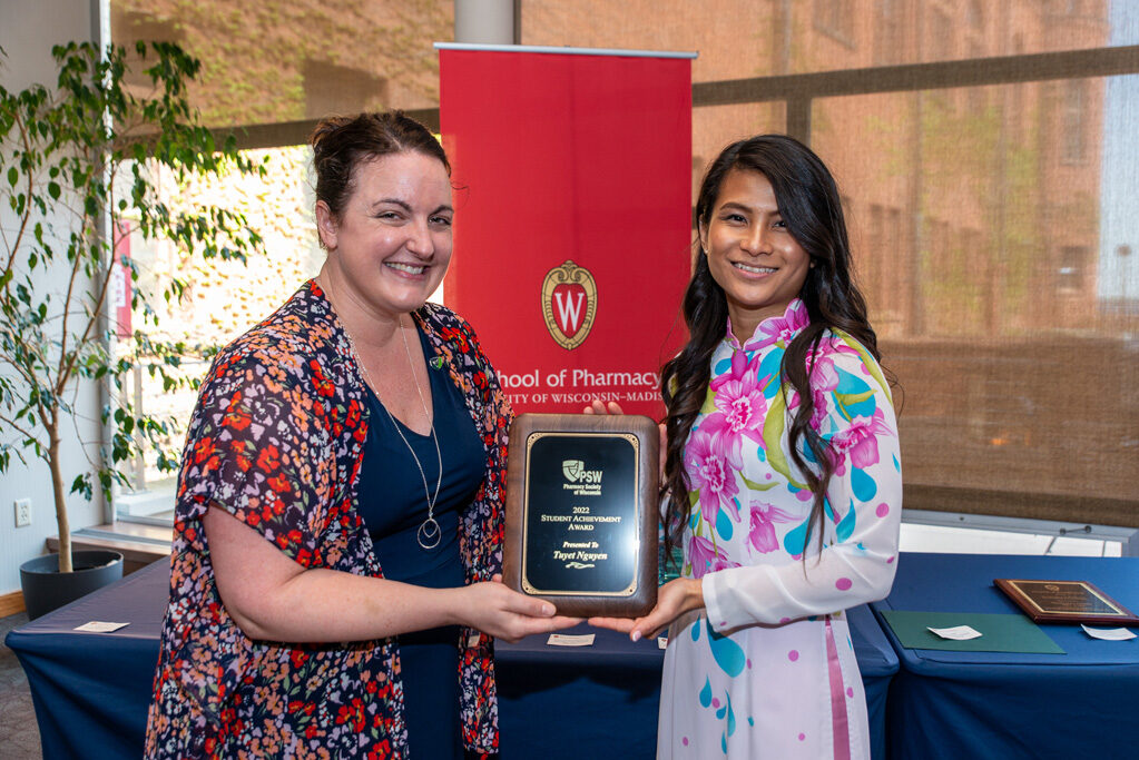 UW Pharm Award recipient holding their award