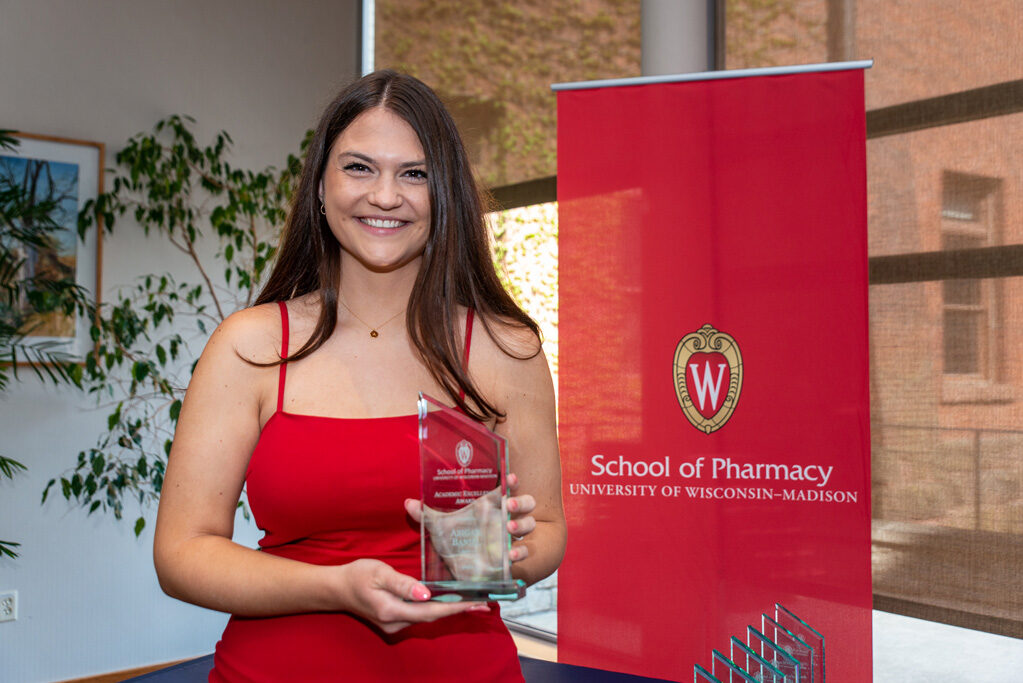 UW Pharm Award recipient holding their award