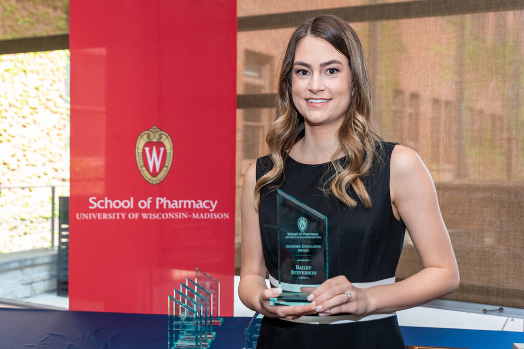 UW Pharm Award recipient holding their award