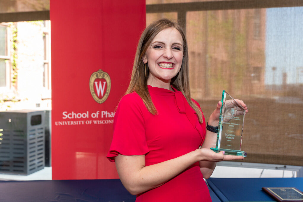 UW Pharm Award recipient holding their award