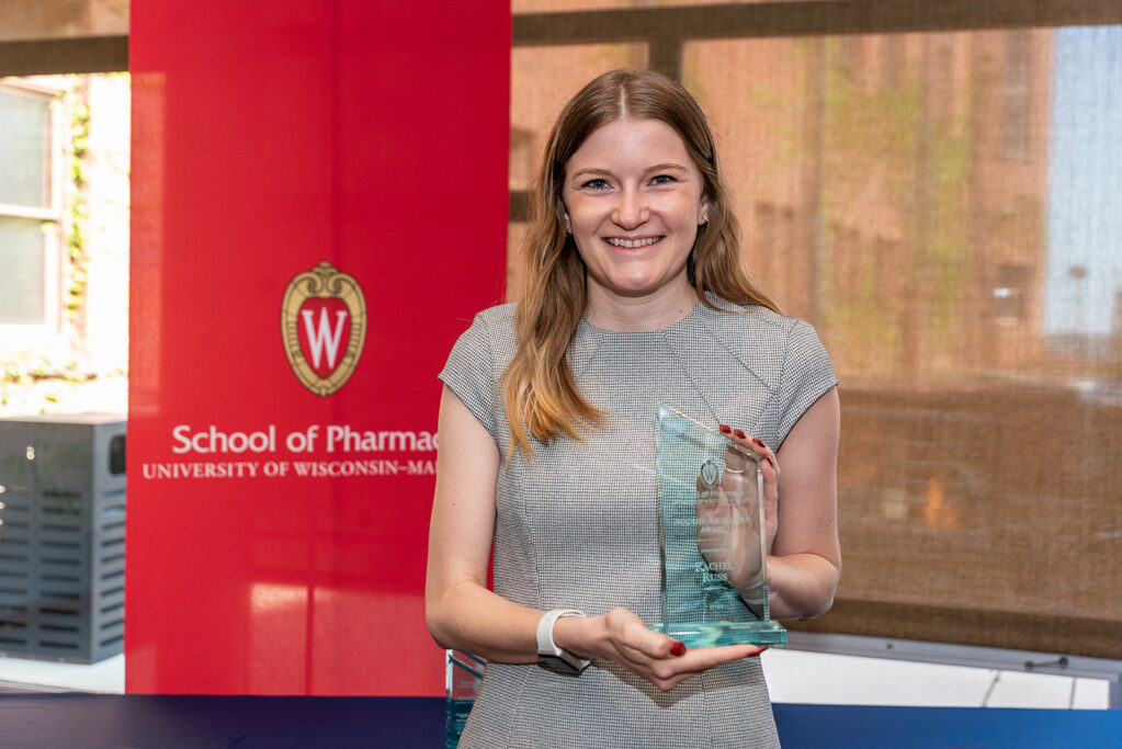 UW Pharm Award recipient holding their award