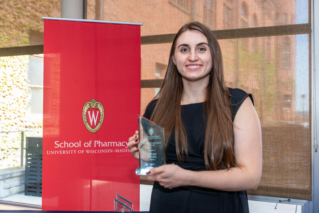 UW Pharm Award recipient holding their award