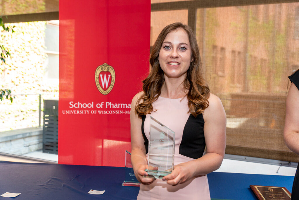 UW Pharm Award recipient holding their award