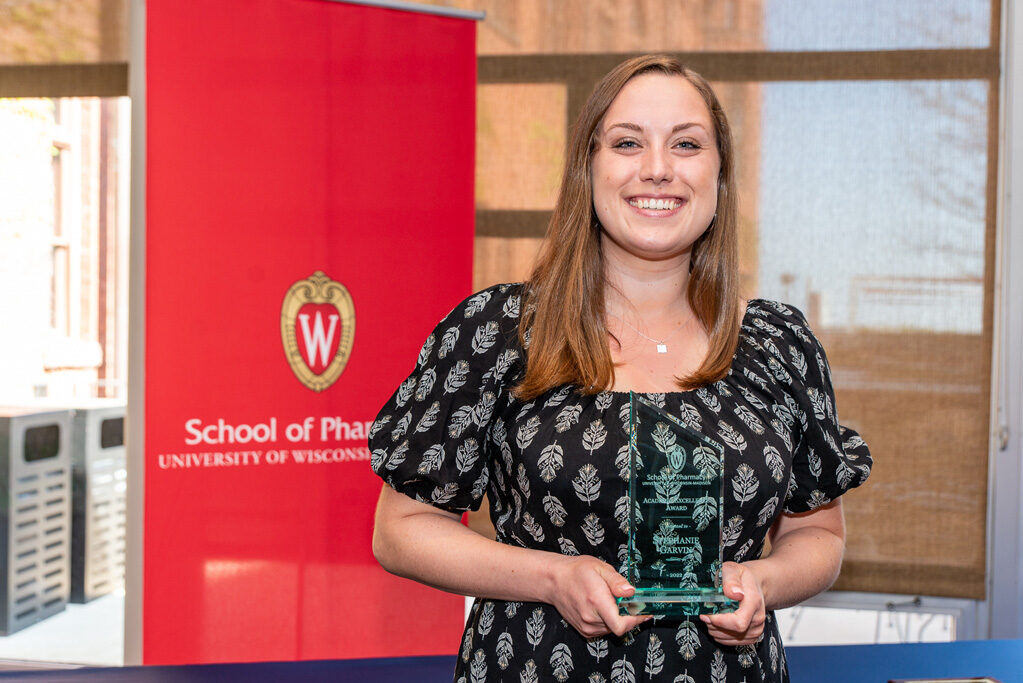 UW Pharm Award recipient holding their award