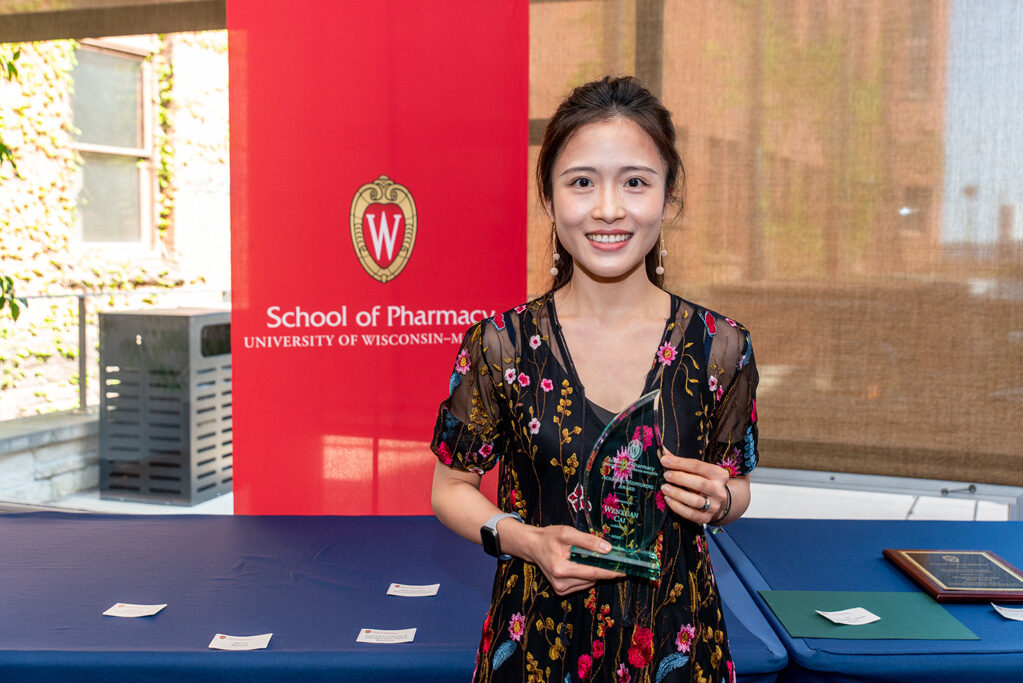 UW Pharm Award recipient holding their award