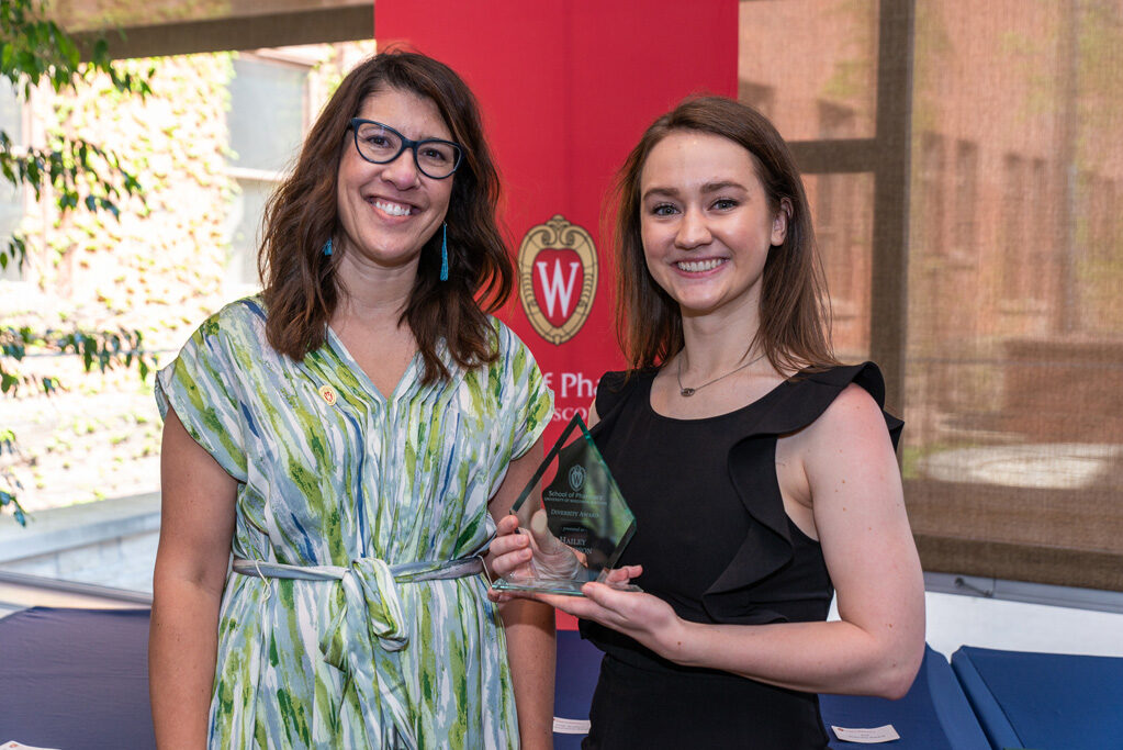 UW Pharm Award recipient holding their award