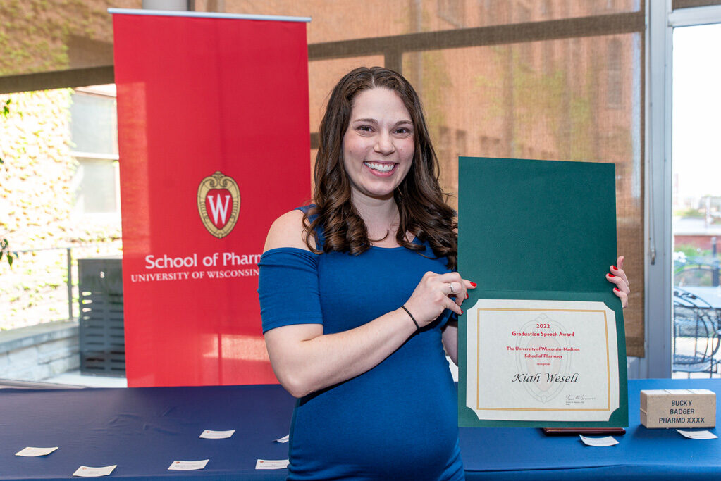 UW Pharm Award recipient holding their award