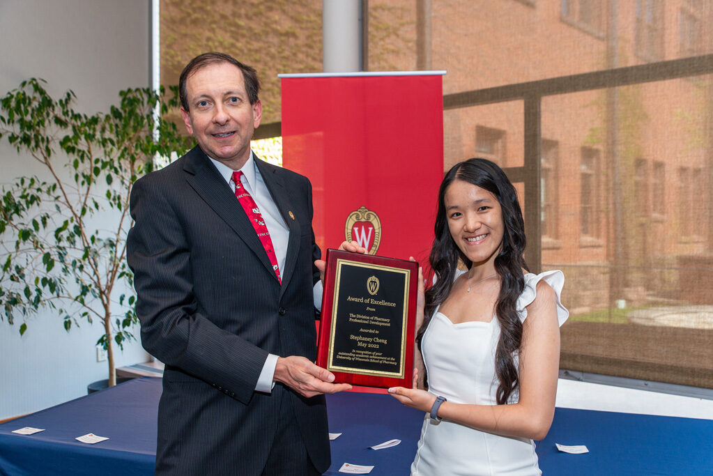 UW Pharm Award recipient holding their award