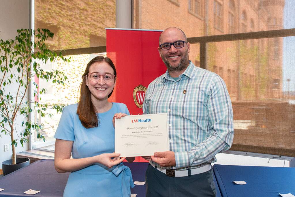 UW Pharm Award recipient holding their award