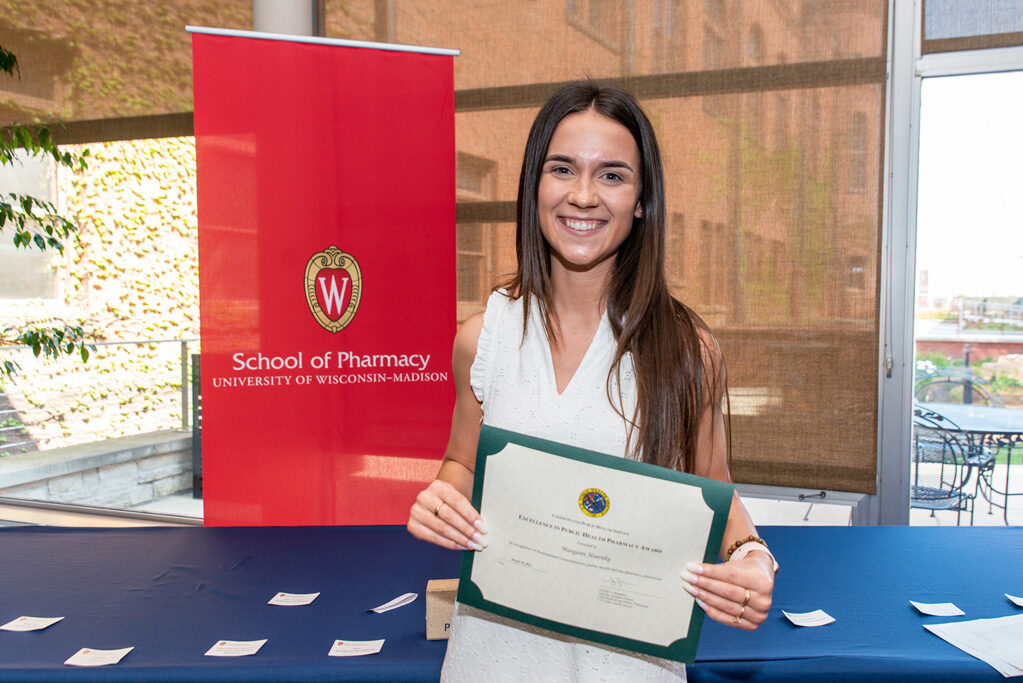 UW Pharm Award recipient holding their award