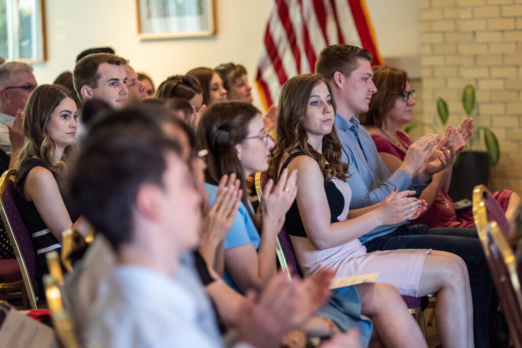 Graduate students clapping in their seats