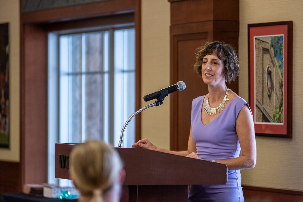 Allison Gardner speaking at the podium