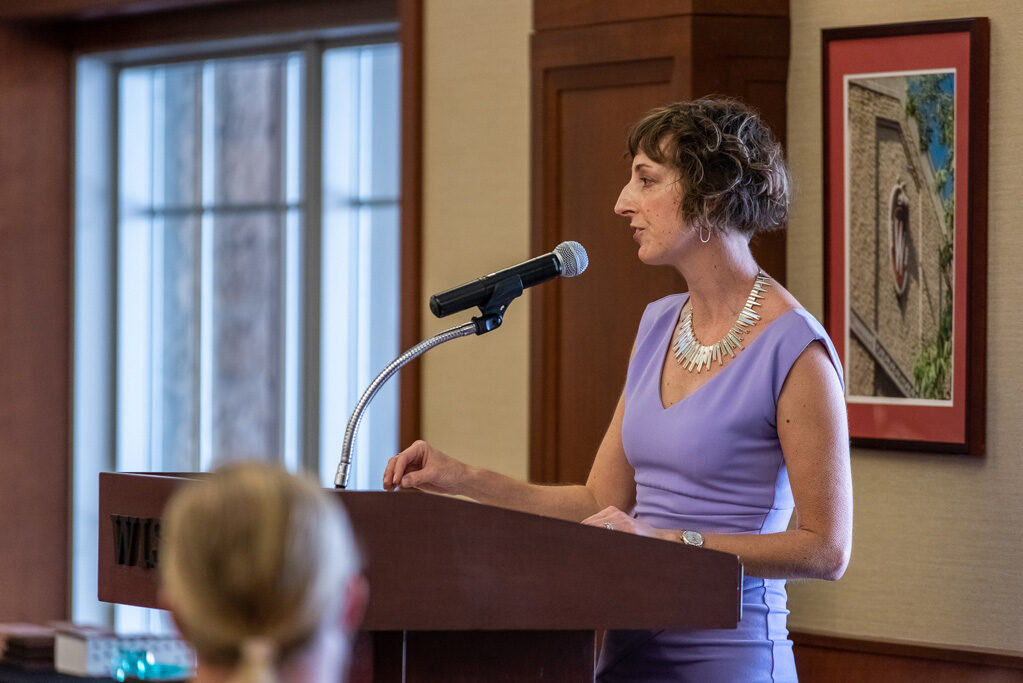 Allison Gardner speaking at the podium