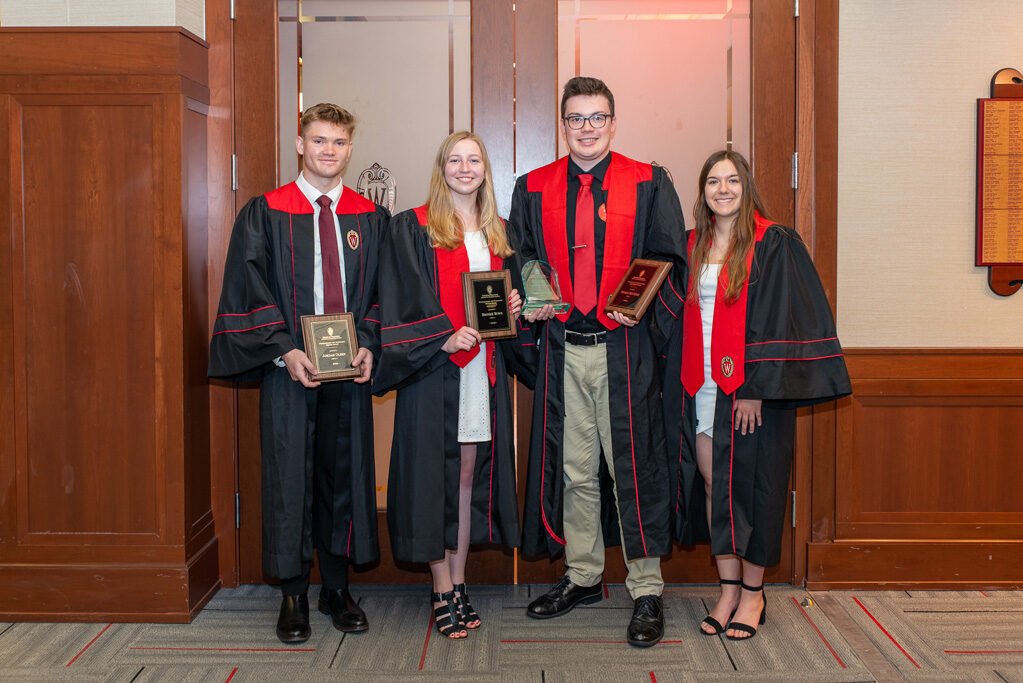 Graduated students holding their awards