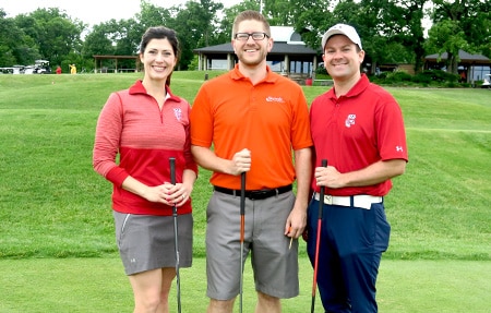 3 pharmacy alums pose together with golf clubs in hand at the annual Scholarship Golf Tournament
