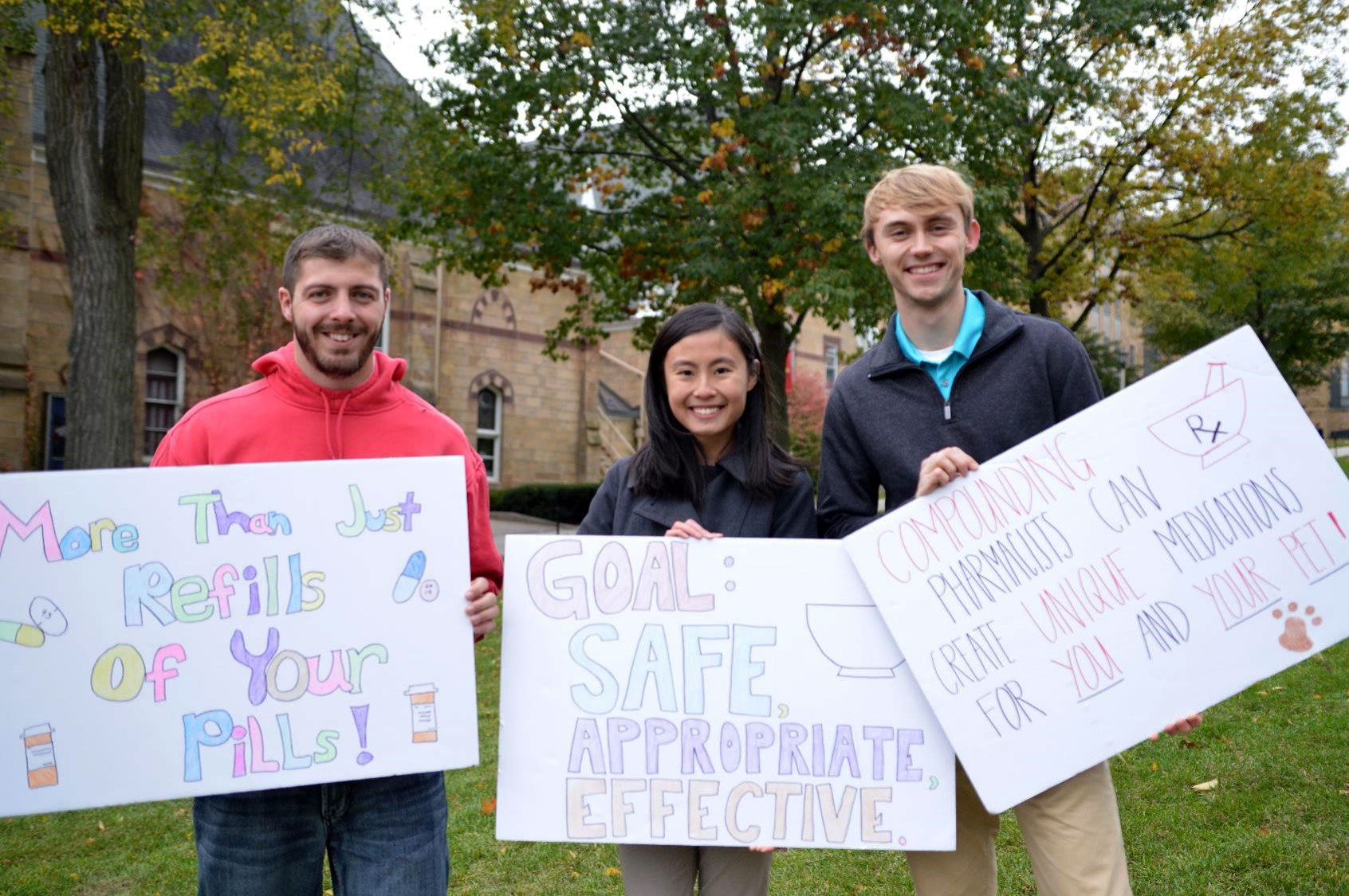 Students groups display signs outside on campus.