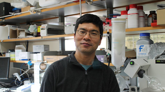 portrait of Weiping Tang in his lab