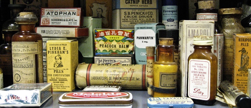 cabinet packed with historic medicines including Peacock Balm, Lydia E. Pinkham's Pills for Constipation, Panwarfin, and Kickapoo pills