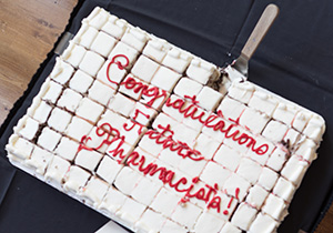 A sheet cake with "Congratulations Future Pharmacists!" printed in icing on the top