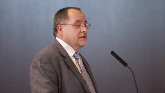 Dr. Mel deVilliers speaking at podium