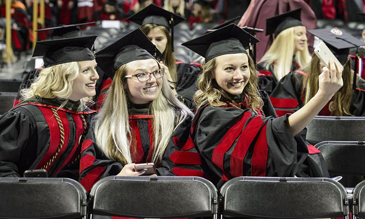 Pharmacy doctoral graduates Taryn Hinners, Lauren Arndt, and Amy Hoffman (left-right) take a selfie at the Kohl Center.