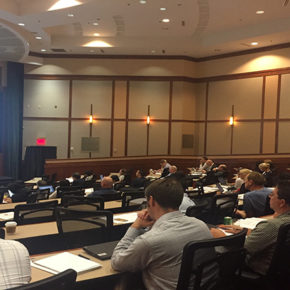 Professionals sitting in lecture hall for conference