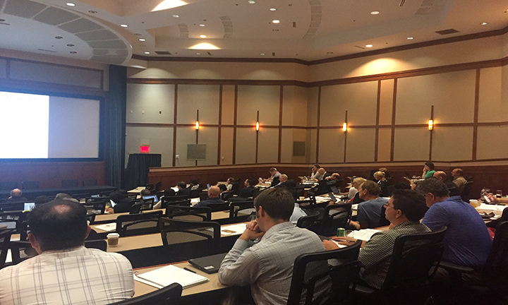 Professionals sitting in lecture hall for conference