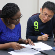 Professor Olayinka Shiyanbola (left) discusses with peer