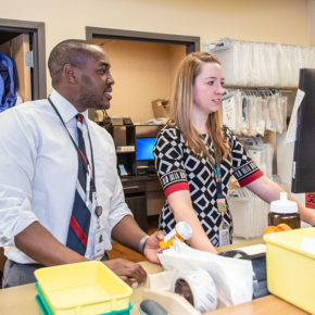 Hussain Harun and Abigail Moore working at station in pharmacy