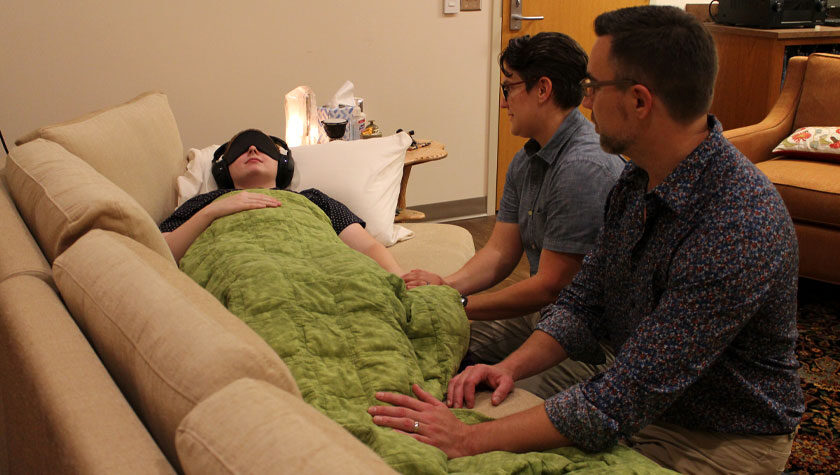 Health practitioners assist a patient during a psilocybin treatment session