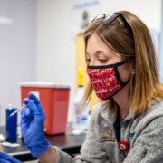 PharmD student Jordyn Kettner gives the Covid vaccine. Photo by Paul L. Newby II